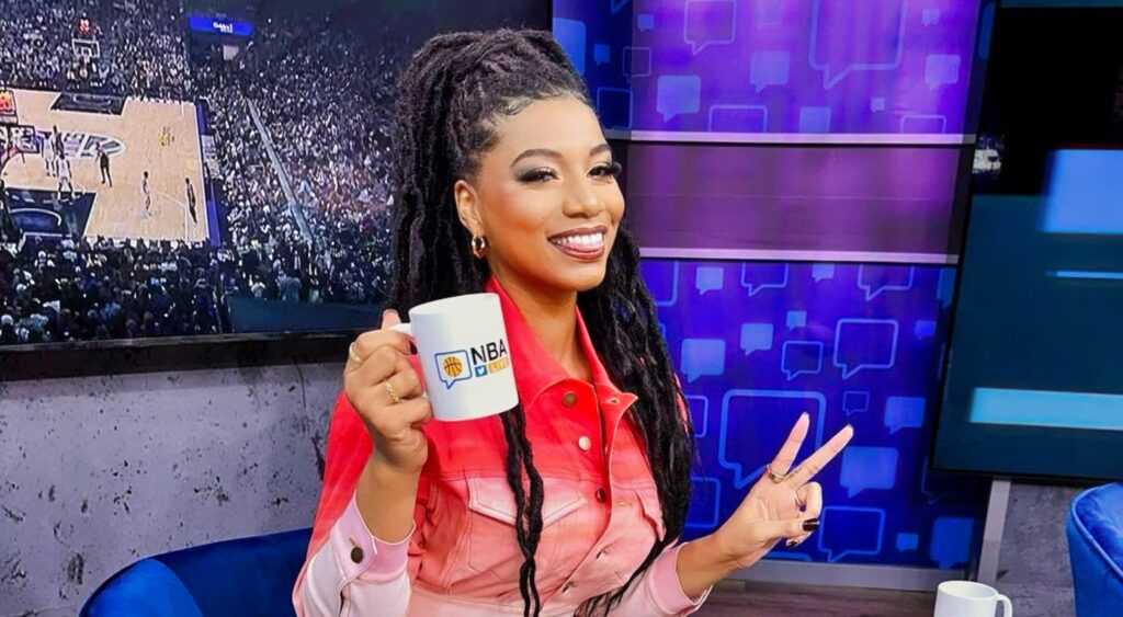 Taylor Rooks holding teacup and two fingers