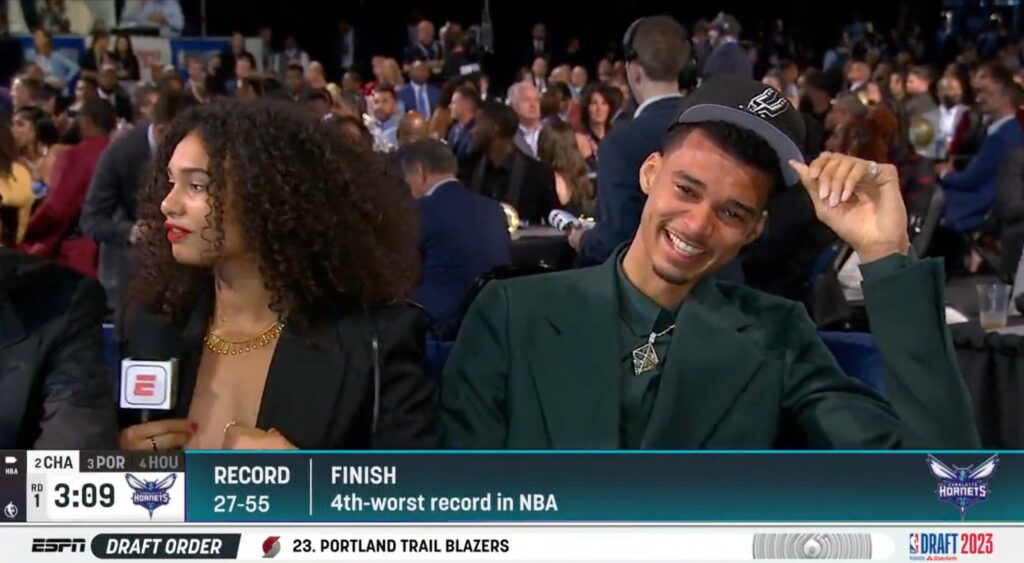 Victor Wembanyama laughs beside his sister at the NBA Draft.
