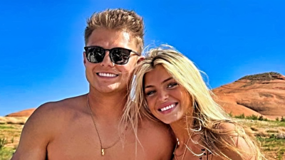 Zach Wilson and girlfriend Nicolette Dellanno smiling while posing together