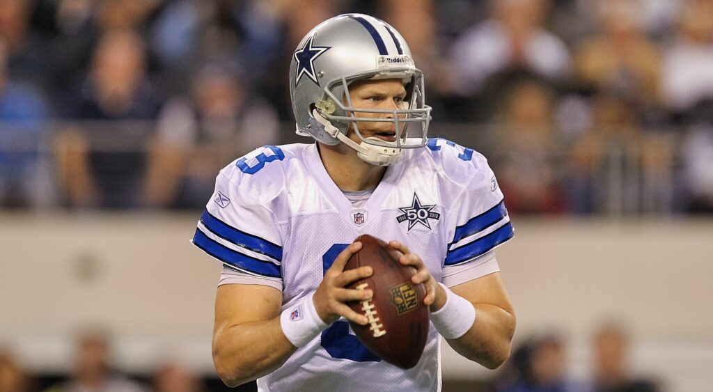 Jon Kitna holding football in Cowboys uniform