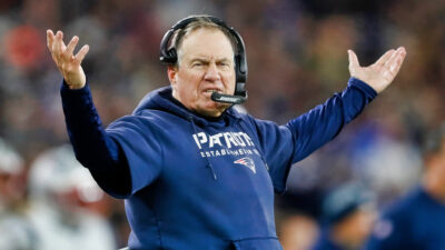 Bill Belichick with his hands in the air