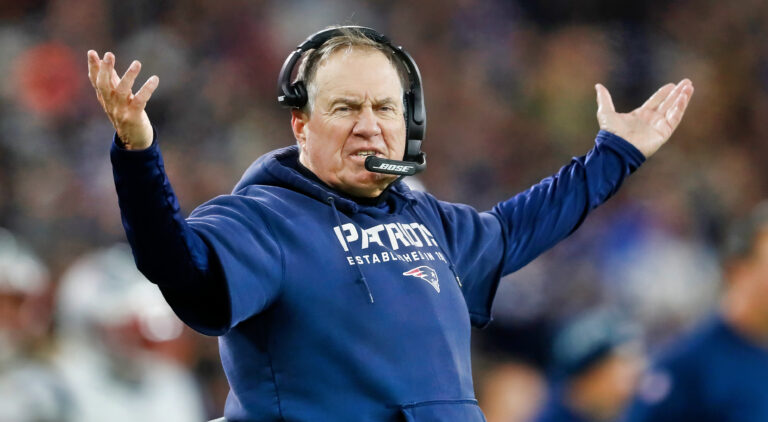 Bill Belichick with his hands in the air