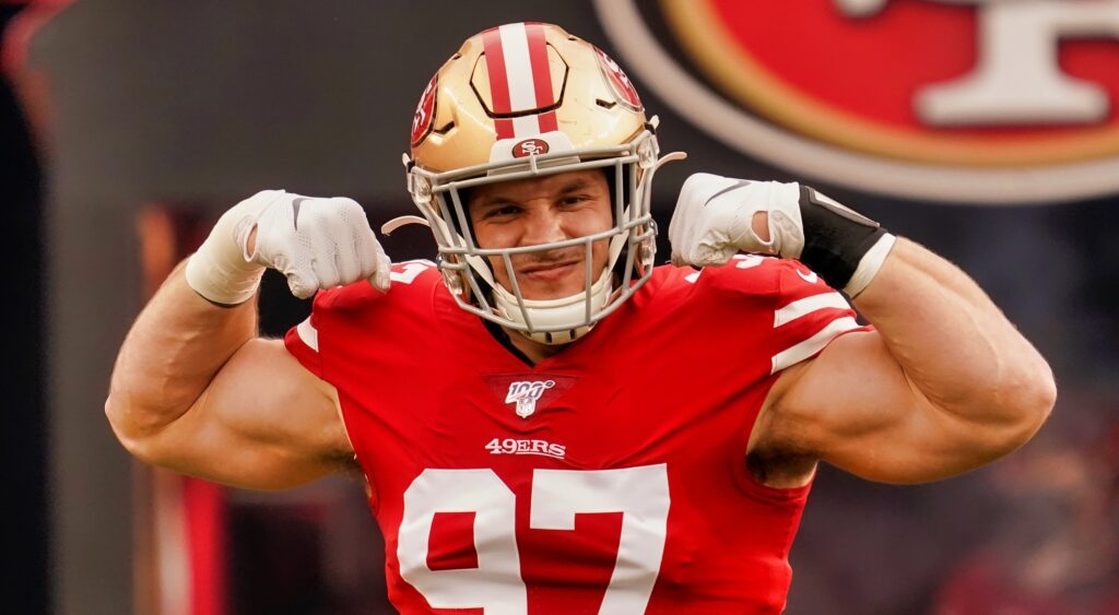 Nick Bosa flexes after making a play during a game.
