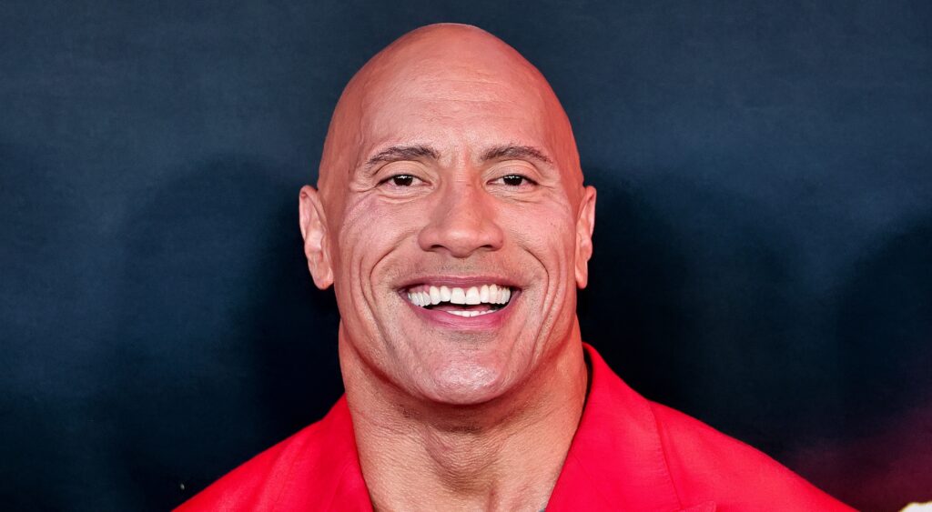Dwayne “The Rock” Johnson posing in red suit