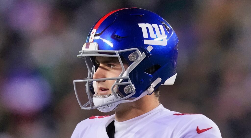 New York Giants' quarterback Daniel Jones looking on.