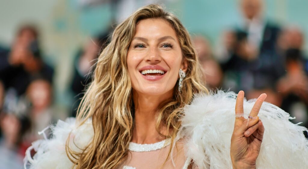 Gisele Bundchen gives the peace sign at the Met Gala.