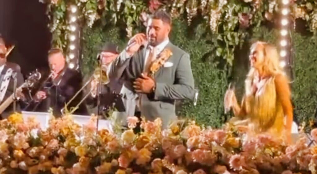 Jordan Mailata sings at his own wedding from the head table.