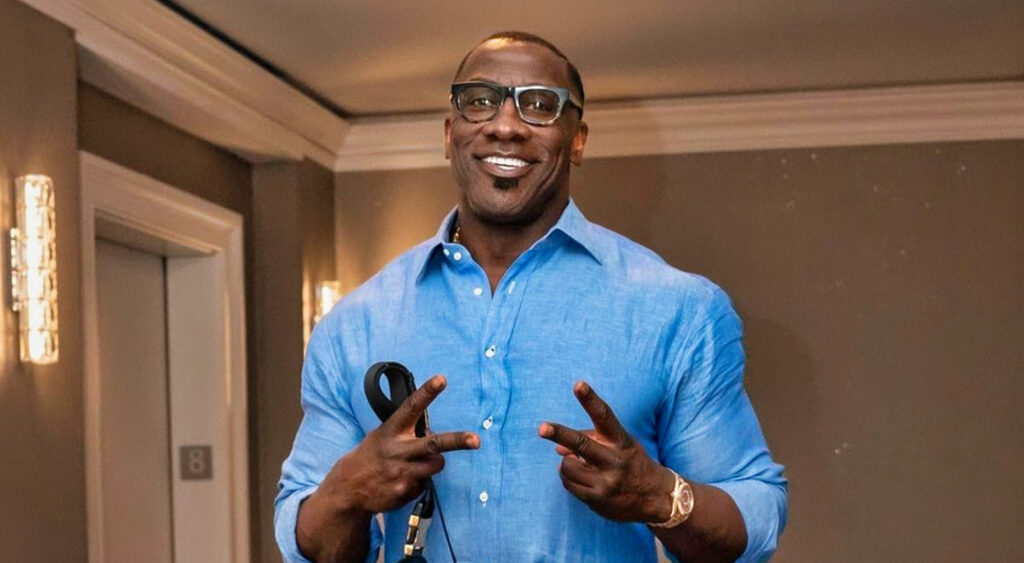 Shannon Sharpe holding up two fingers on both hands
