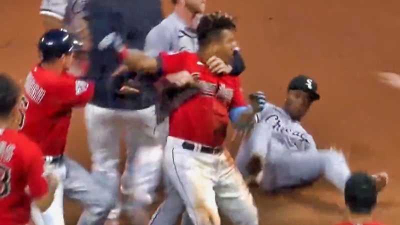 José Ramírez of Cleveland Guardians being held back after punching Tim Anderson of Chicago White Sox.