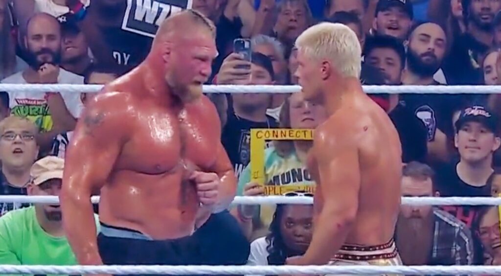 Brock Lesnar stares down Cody Rhodes in the ring.