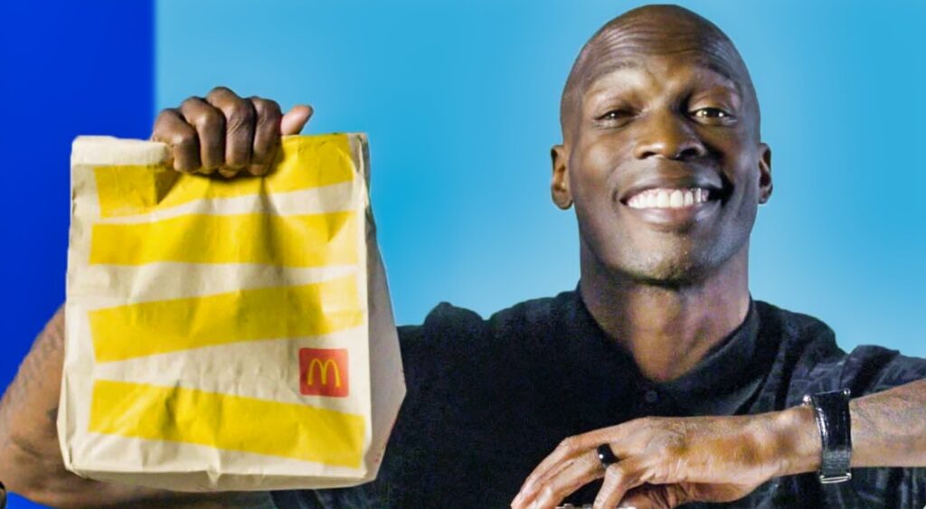 Chad Ochocinco holds up a McDonalds bag.