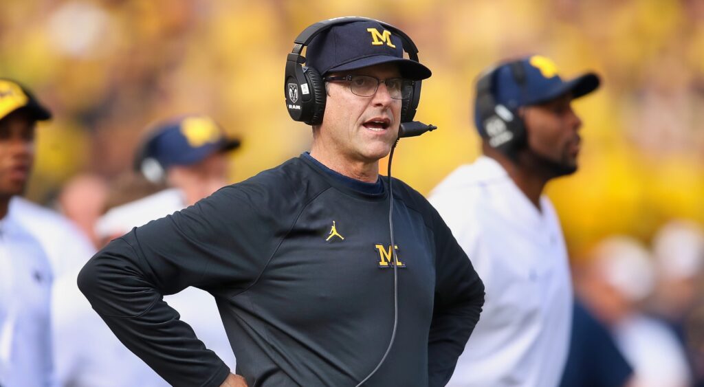 Jim Harbaugh with his arms on his hips