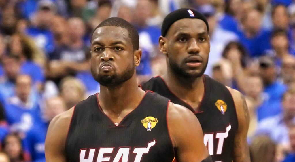 Dwyane Wade scowling with LeBron james in the background