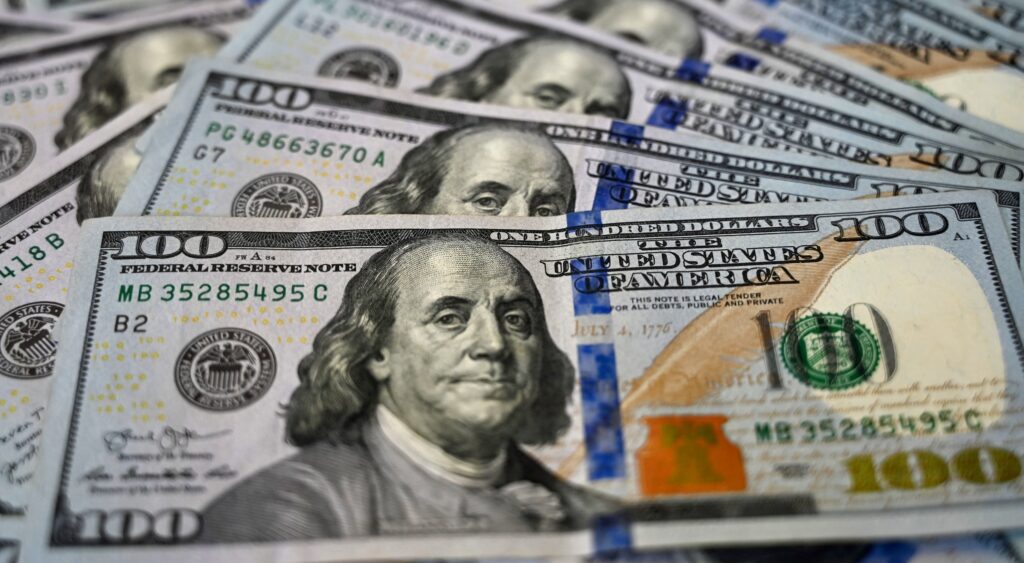 100 dollar american bills spread out.