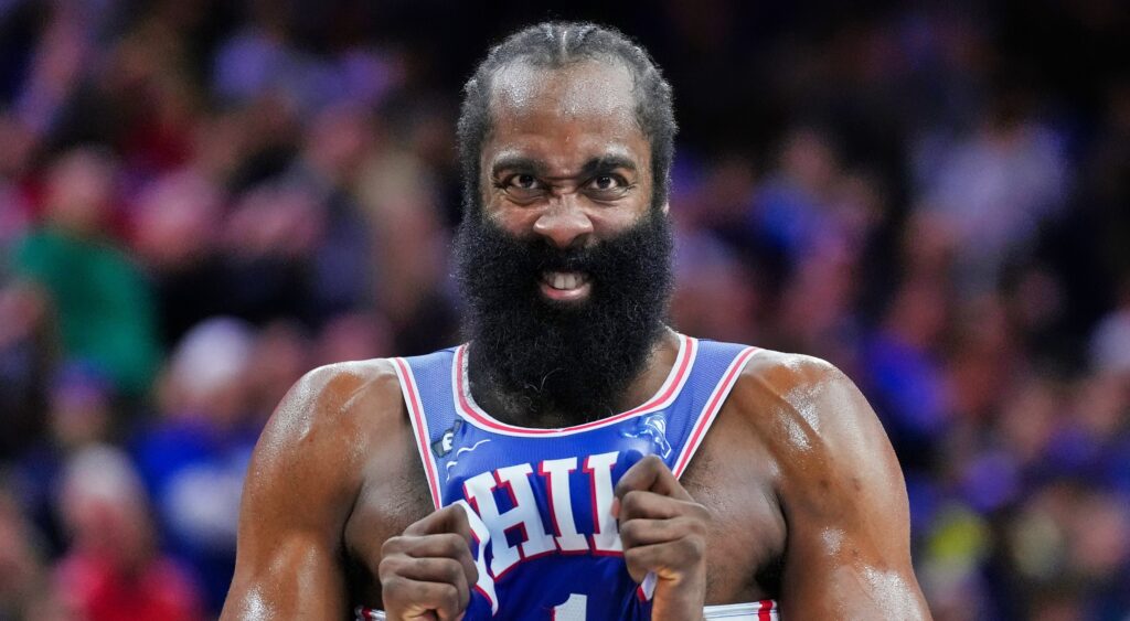 James Harden pulls on his jersey during a game.