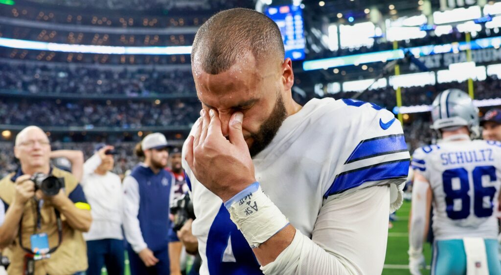 Dak Prescott wipes his eyes after a game.