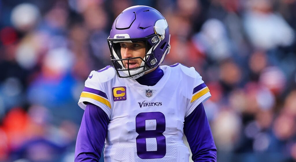 Minnesota Vikings' quarterback Kirk Cousins looking on.