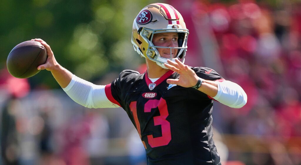 San Francisco 49ers' quarterback Brock Purdy throwing pass.