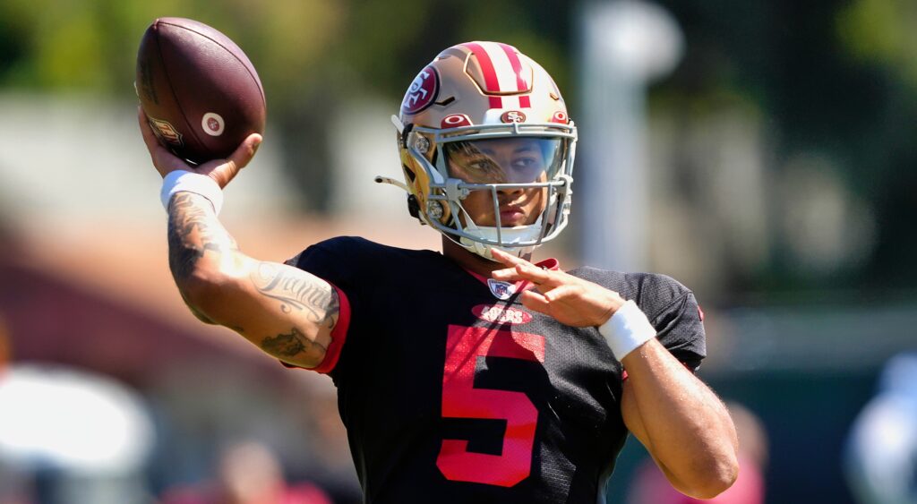 San Francisco 49ers' quarterback Trey Lance throwing at training camp.
