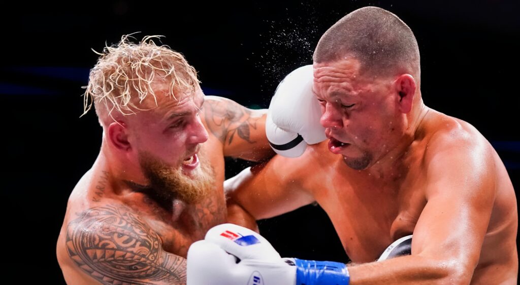 Jake Paul punches Nate Diaz during their boxing match.