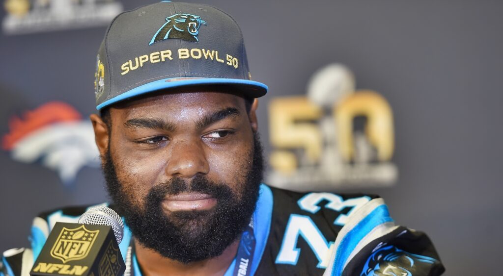 Michael Oher looks on during a press conference.