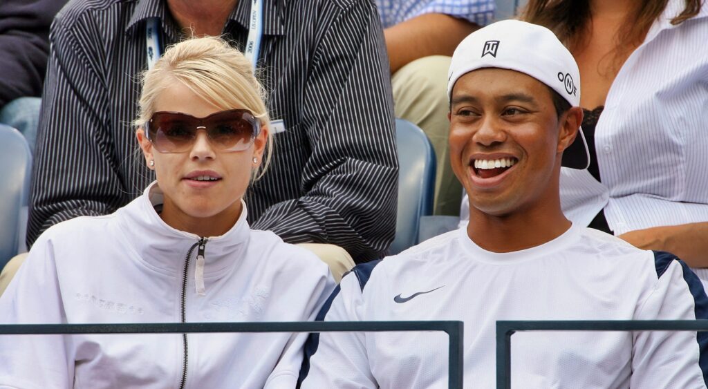 Tiger Woods and Elin Norgegren watch a tennis match.