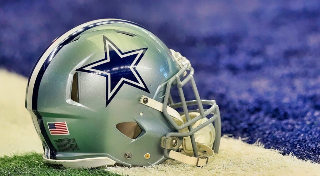 Dallas Cowboys' helmet shown on AT&T Stadium field.