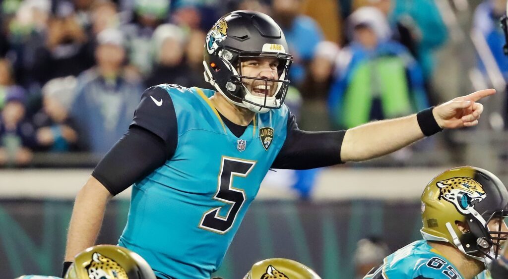Blake Bortles points at a defender at the line of scrimmage.