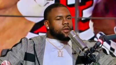 Mark Ingram talking into podcast microphone