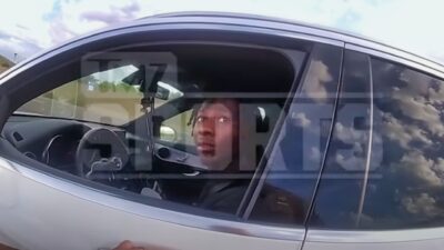 Marquise Brown in his car looking at cop