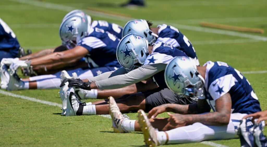 Dallas Cowboys players stretch at practice.