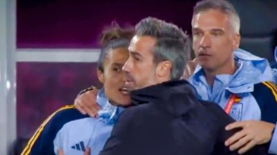 Spanish coach and two assistants embracing
