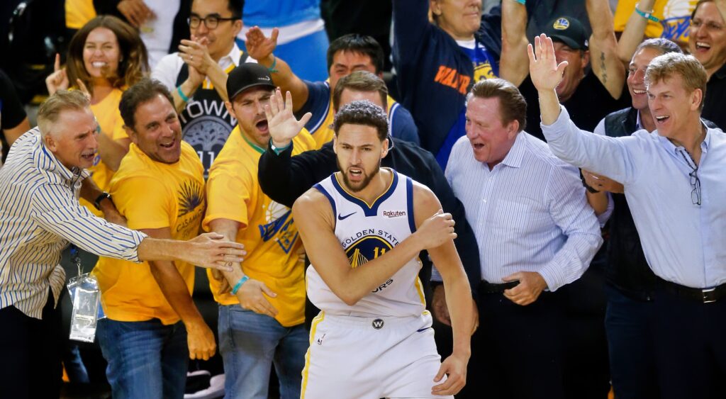 Warriors fans swarm Klay Thompson after he hits a shot.