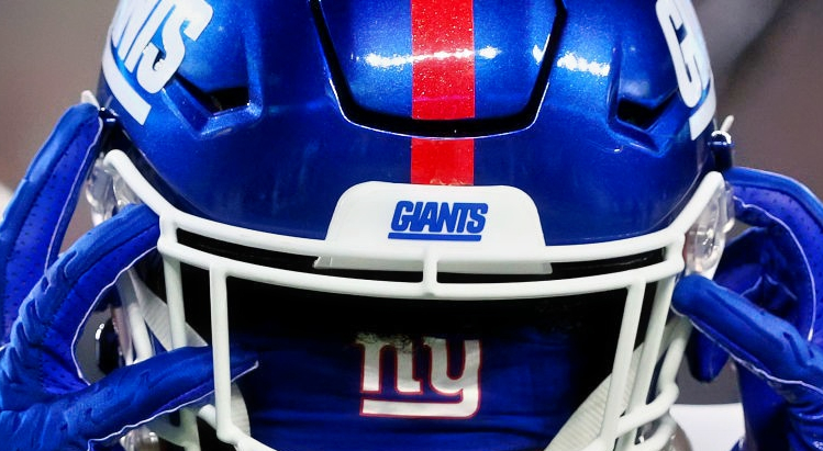 Giants player taking off helmet.
