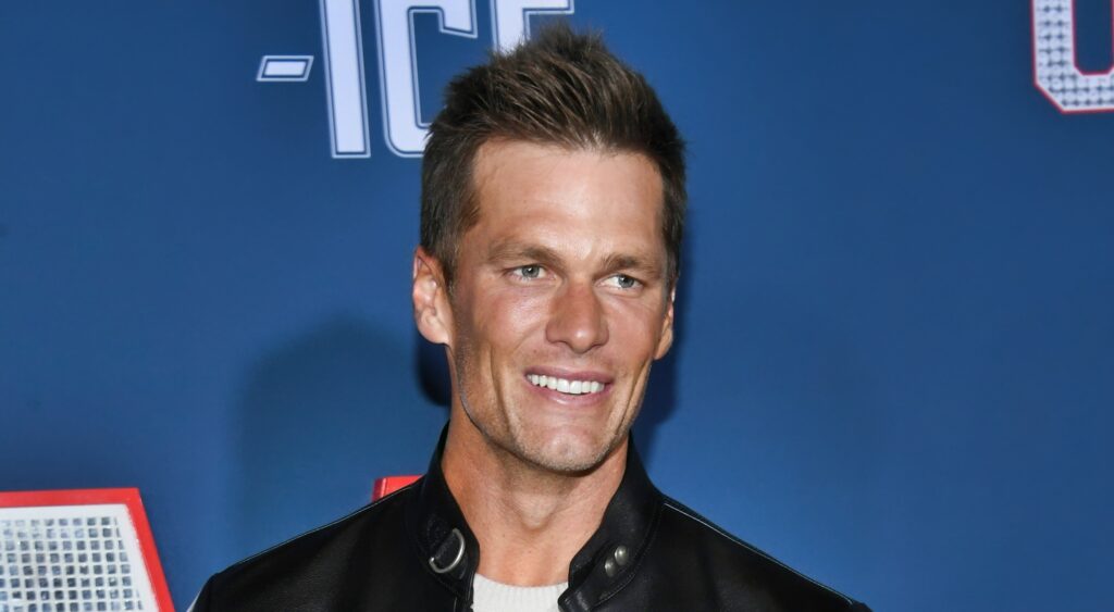 Tom Brady smiling at "80 For Brady" premiere.