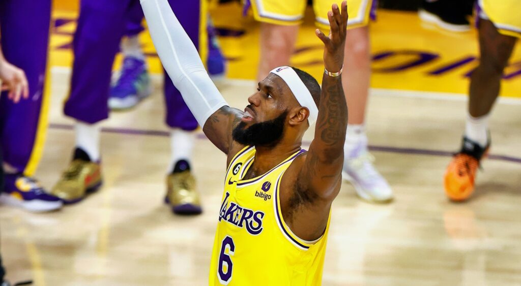 LeBron James holds his arms in the air.
