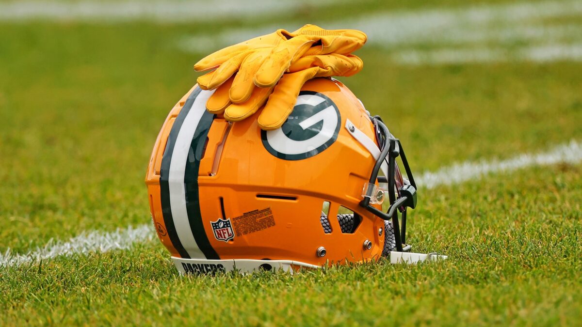 Packers helmet with glove on it