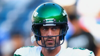 Aaron Rodgers wearing Jets helmet