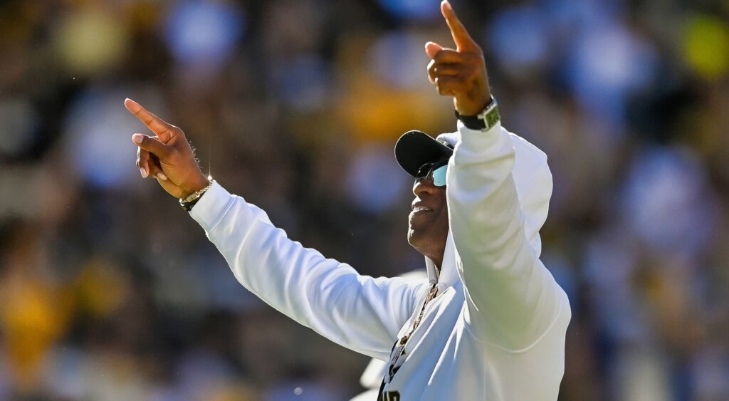 Deion Sanders holds up his hands to the crowd at Colorado.