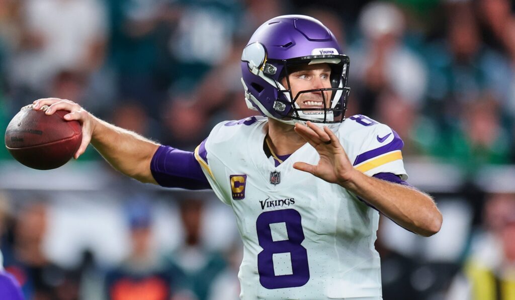 Minnesota Vikings' quarterback Kirk Cousins throwing football.