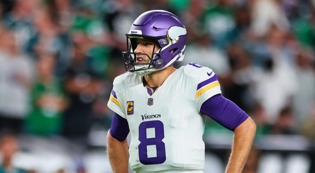 Minnesota Vikings' quarterback Kirk Cousins looking on.