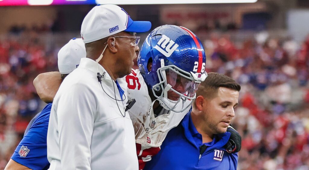 Saquon Barkley being helped by trainers