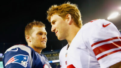 Tom Brady embracing Eli Manning
