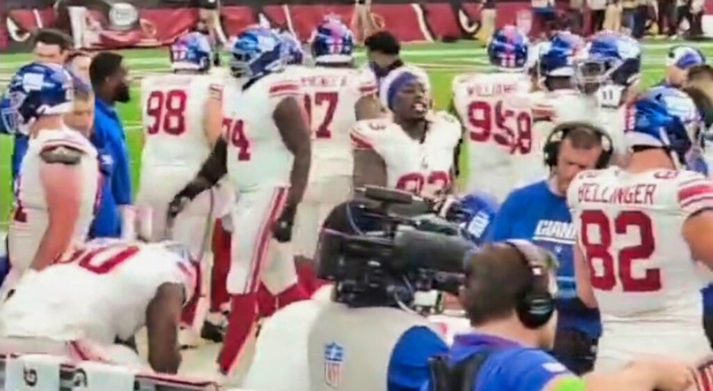 Giants players on the sideline.