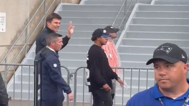 Tom Brady waving as he returns to Gillette Stadium.