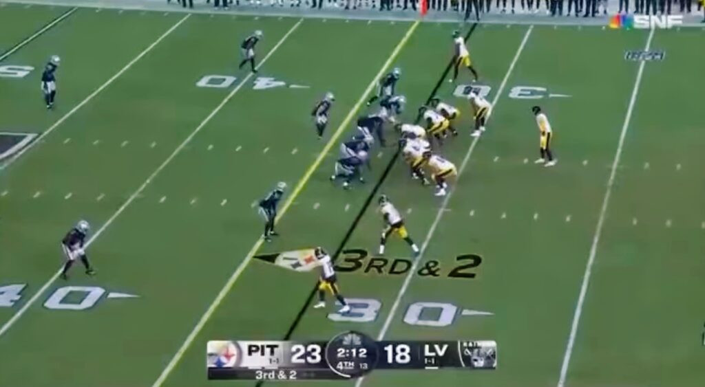 Steelers offense lined up for a  play against the Raiders.