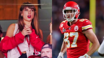 Taylor Swift with hands on chest. Kelce in uniform