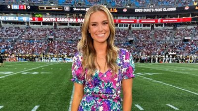 Molly McGrath posng in dres on field