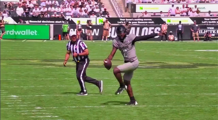 Colorado Buffaloes' quarterback Shedeur Sanders running with football.