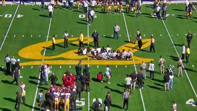 Protesters sit at midfield of USC-California game.